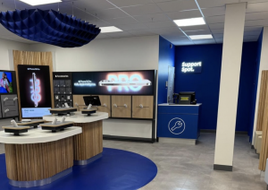 builders cleaning services removing construction dust in a phone shop. Showing a clean shop floor.